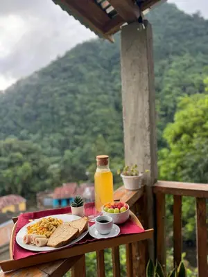 a breakfast plate of food and a bottle of orange juice at Cabañas en las Montañas in San Cristóbal