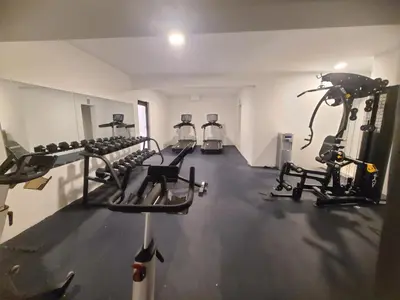 a gym with several tread machines in a room at Lujoso exclusivo próximo monumento in Santiago de los Caballeros