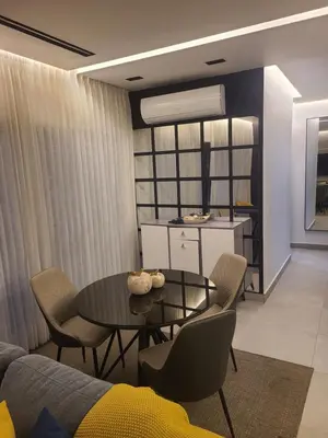 a dining room with a table and chairs and a kitchen at Lujoso exclusivo próximo monumento in Santiago de los Caballeros