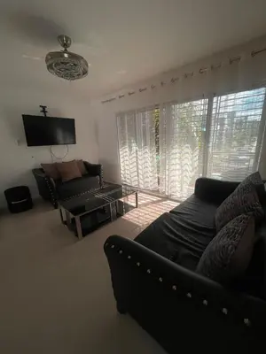 a living room with a couch and a tv at Apartment in Harmony I in Santiago de los Caballeros
