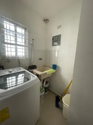 a small white kitchen with a sink and a window at Apartment in Harmony I in Santiago de los Caballeros