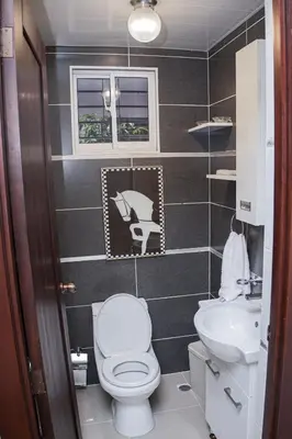 a small bathroom with a toilet and a sink at Beautiful condo in La Vega in Concepción de La Vega