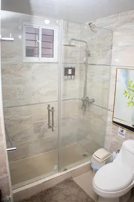 a shower stall in a bathroom with a toilet at Beautiful condo in La Vega in Concepción de La Vega