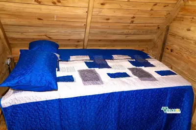 a blue and white bed in a room at Villasol Pedernales in Pedernales