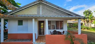 a small white house with a pitched roof at Villa Jardín Tropical in Las Galeras