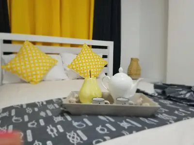 a tray with a tea set on top of a bed at Vamar Apartamentos in San Felipe de Puerto Plata