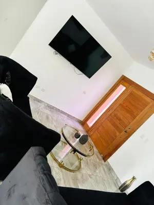 a living room with a couch and a television at El Rincon Soleado in San Felipe de Puerto Plata
