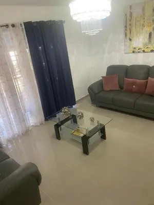 a living room with a couch and a coffee table at Cozy, comfortable three-bedroom condo in Santiago,DR in Santiago de los Caballeros
