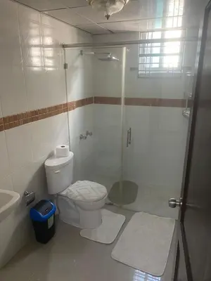 a bathroom with a shower and a toilet and a sink at Cozy, comfortable three-bedroom condo in Santiago,DR in Santiago de los Caballeros
