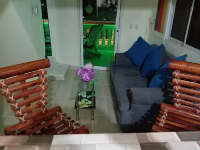 a living room with two chairs and a couch at Dona Beba Guesthouse in La Caleta