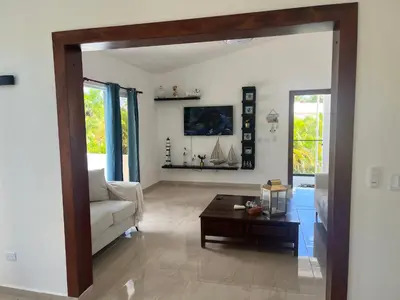 a living room with a couch and a table at Villa Jardín Tropical 2 in Las Galeras