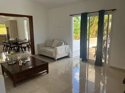 a living room with a couch and a coffee table at Villa Jardín Tropical 2 in Las Galeras