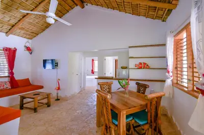 a living room with a wooden table and chairs at Paradiso del Caribe Apartments A1 and A2, Your Perfect Stay in Las Galeras in Las Galeras