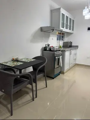 a kitchen with a table and a stove at Elida Oceanfront Rentals in Sampiño