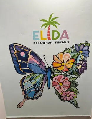 a drawing of a butterfly with flowers at Elida Oceanfront Rentals in Sampiño