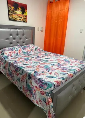 a bedroom with a bed with a quilt on it at Elida Oceanfront Rentals in Sampiño