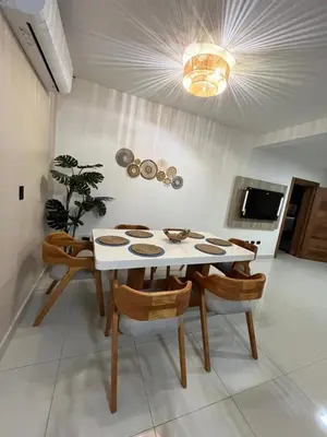 a dining room with a white table and chairs at GH Condos by Sunrise3 in Puerto Plata