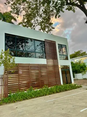 a building with wooden doors and windows on a street at GH Condos by Sunrise1 in San Felipe de Puerto Plata