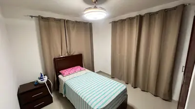 a small bedroom with a small bed and a dresser at AP Filathefia 01 in San Isidro