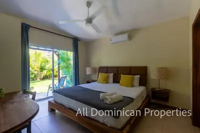 a bedroom with a bed and a large window at Sosua Private villa, 9 br, guest friendly, Up to 20 persons! in Sosúa