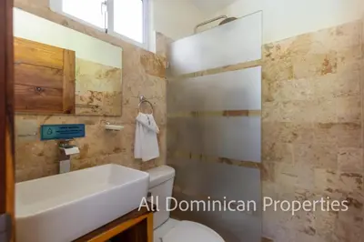a bathroom with a sink and a toilet at Sosua Private villa, 9 br, guest friendly, Up to 20 persons! in Sosúa