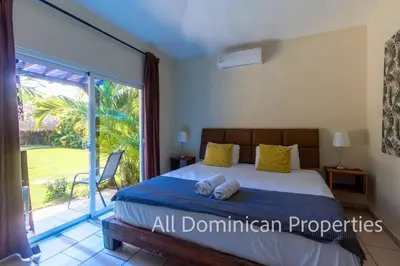 a bedroom with a bed and a large window at Sosua Private villa, 9 br, guest friendly, Up to 20 persons! in Sosúa