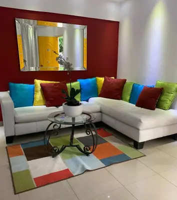 a living room with two couches and a table at VILLAS SONJASAA LOFt in Baní