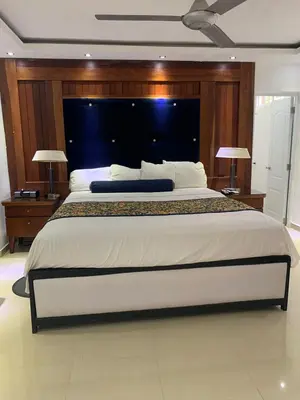 a bedroom with a large bed with two tables and two lamps at VILLAS SONJASAA LOFt in Baní