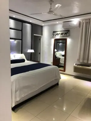 a bedroom with a large bed and a mirror at VILLAS SONJASAA LOFt in Baní