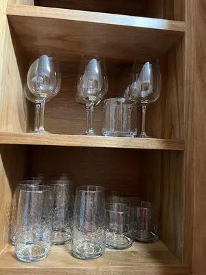 a bunch of glasses sitting on a wooden shelf at GH Condos by Sunrise2 in San Felipe de Puerto Plata