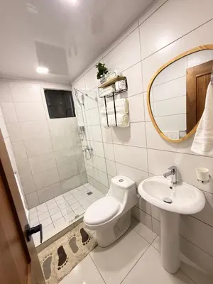 a bathroom with a toilet and a sink and a mirror at GH Condos by Sunrise2 in San Felipe de Puerto Plata