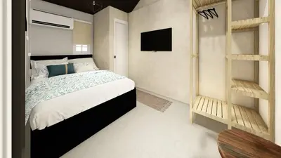 a bedroom with a bed and a television in it at Santa's Villa Punta Rucia in Punta Rucia