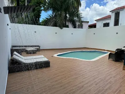 a swimming pool in the backyard of a house at Solano Apartamentos in Boca Chica