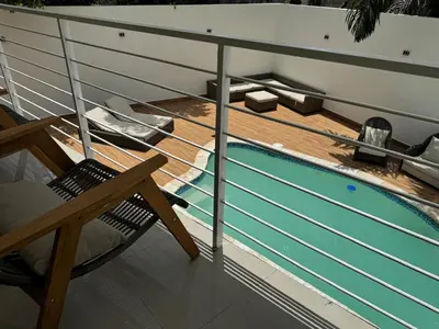 a deck with a swimming pool on a cruise ship at Solano Apartamentos in Boca Chica