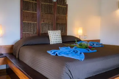 a bed with two blue towels on top of it at Penthouse beach front in Las Terrenas