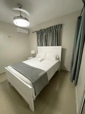 a white bed in a room with a window at 3 bedroom apartment with private jacuzzi and terrace in Ensanche Savica de Mendoza