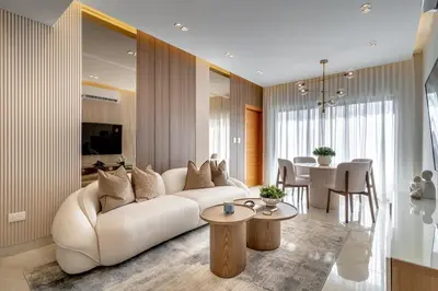 a living room with a white couch and a table at Luxury apt city views in the center of the city in Santo Domingo