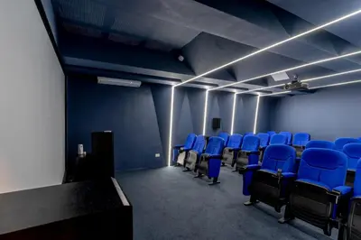 a room with blue chairs and a table and lights at Luxury apt city views in the center of the city in Santo Domingo