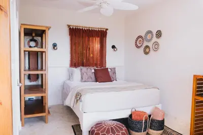 a white bedroom with a bed and a window at Araya Resort in Las Galeras