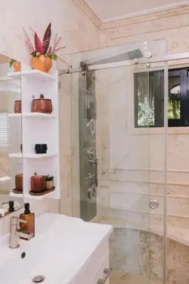 a bathroom with a shower and a white sink at Araya Resort in Las Galeras