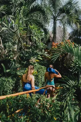 a man and a woman in blue bathing suits in a garden at Araya Resort in Las Galeras