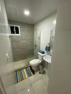 a bathroom with a toilet and a shower and a sink at Apartamento en Higuey City Home in Higuey