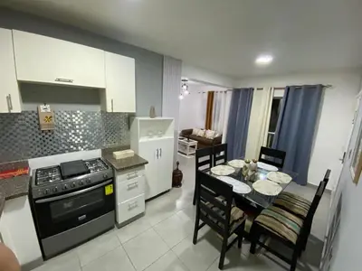 a kitchen with a table and a stove top oven at Apartamento en Higuey City Home in Higuey