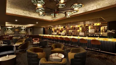 a restaurant with a bar with chairs and tables at Moon Palace The Grand Punta Cana in Punta Cana