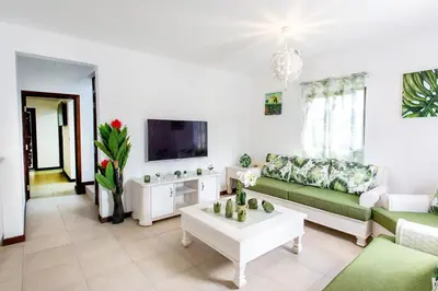 a living room with a couch and a tv at Villa Retreat in Ibiza, Punta Cana in Punta Cana