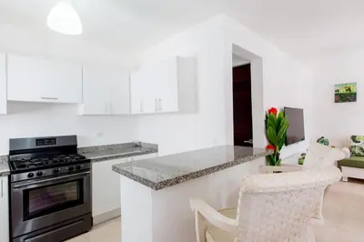 a kitchen with white cabinets and a counter top at Villa Retreat in Ibiza, Punta Cana in Punta Cana