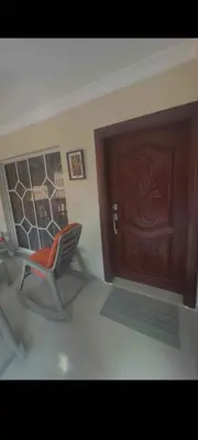 a room with a chair and a wooden door at Casa entrada el cachon lucerna in Cancino Adentro