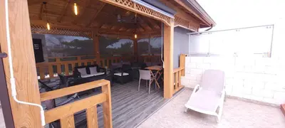 a patio with chairs and tables on a deck at Casa entrada el cachon lucerna in Cancino Adentro