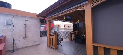 an open door to a patio with a tv on a building at Casa entrada el cachon lucerna in Cancino Adentro