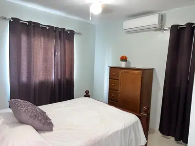 a bedroom with a bed and a dresser and a window at Tranquilo Apartamento de 3 habitaciones in Los Paredones